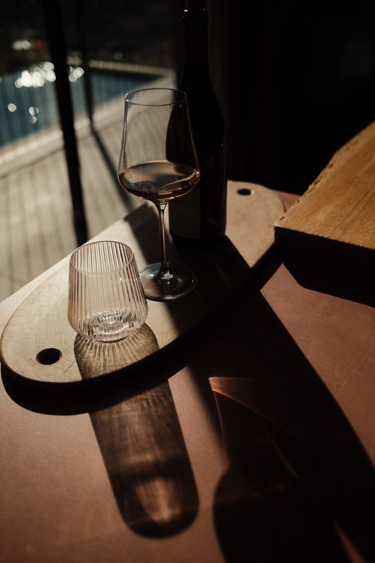Handcrafted oval oak serving board with visible growth rings and epoxy-filled cracks, featuring side holding openings for serving or wall display.
